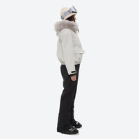 
                  
                    Women's fur trim hood snow jacket with suspender bibs - white fur trim hood jacket with black bib pants, on-model side view
                  
                