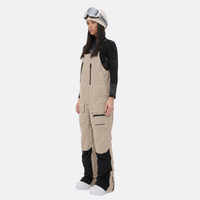 
                  
                    Women's breathable 3-layer suspender ski pants - tan bib snow pants with black top, for resort and backcountry days
                  
                