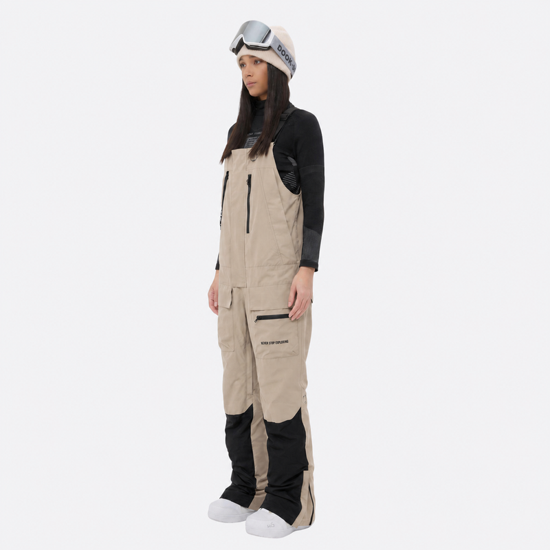 Women's breathable 3-layer suspender ski pants - tan bib snow pants with black top, for resort and backcountry days